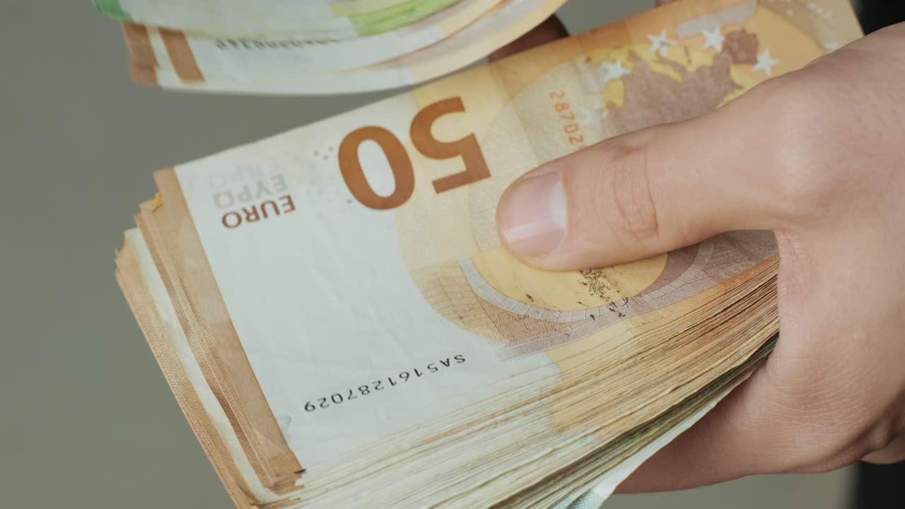 Men's hands quickly count banknotes. Businessman counts banknotes of euro in hands.