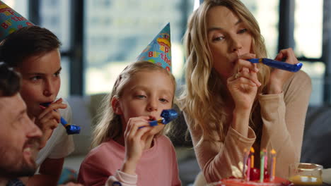 Mom-dad-kids-celebrating-birthday-online.-Happy-family-having-fun-party-blowers.