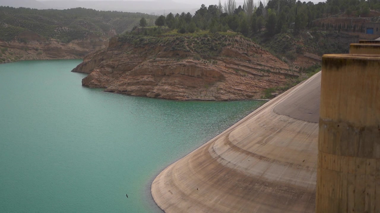 Presa del Negratin dam, turquoise water, rocky landscape, tranquil atmosphere