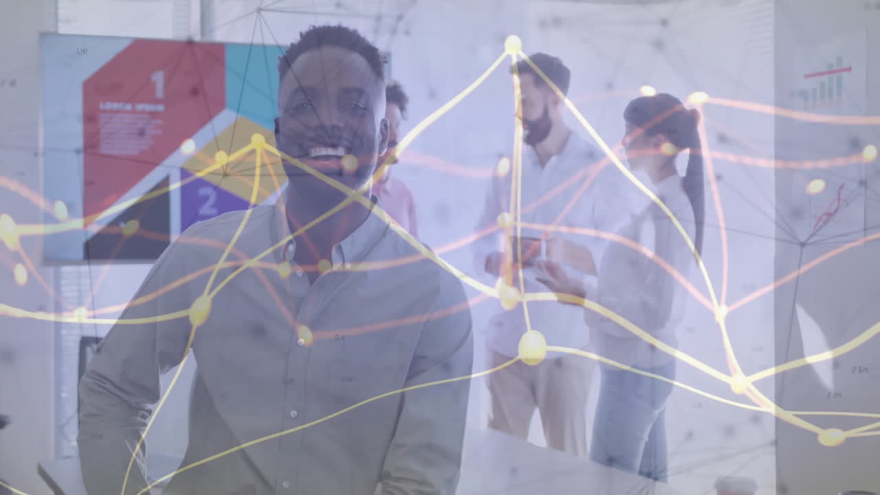Smiling man in office with data processing animation over colleagues discussing