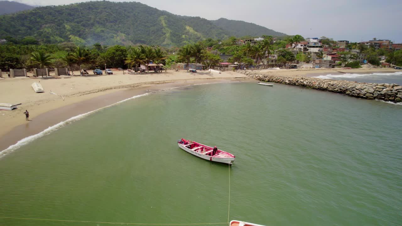 Aerial drone shot of a fisherman on a small boat fishing off the coast of Bahia