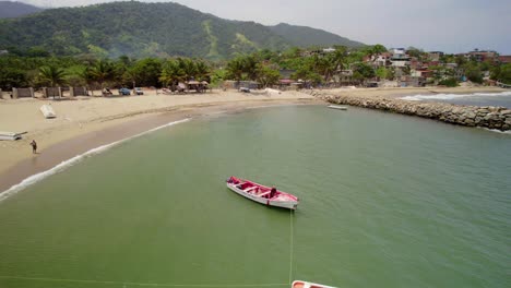 aerial drone shot of a fisherman on a small boat fishing off the coast of bahia