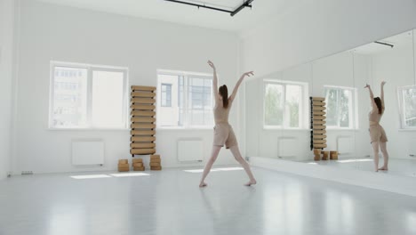 young woman in a white studio practicing contemporary dance