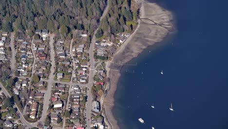 Seaside-Houses-and-Sailboats-near-the-Coast-High-Aerial-View