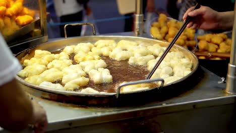 frying deep-fried dough stick in the pan at yaowarat road chinatown, a popular travel destination in bangkok, thailand