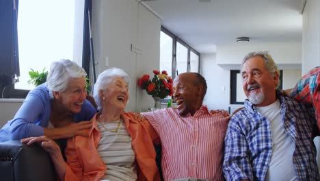 happy senior friends having fun while relaxing on sofa 4k