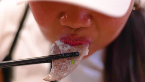 person eating with chopsticks in hong kong