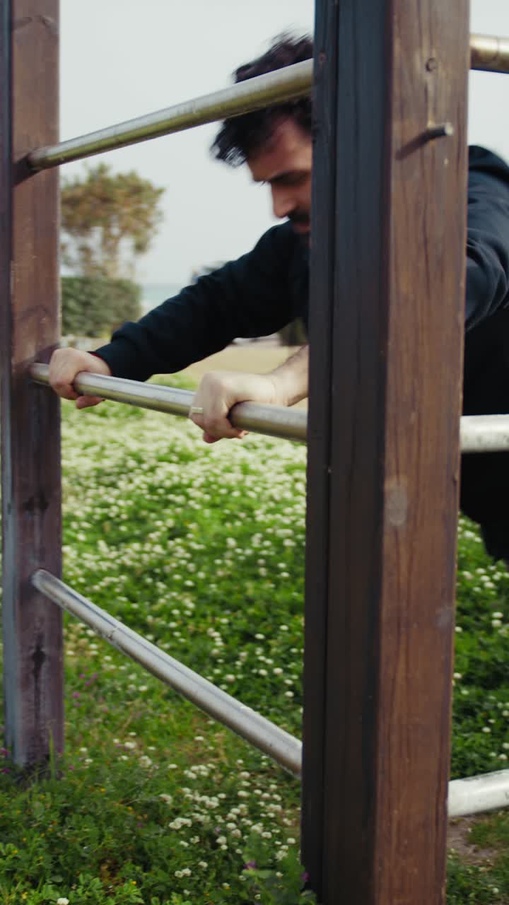 Man Stretching on Outdoor Pull-up Bars