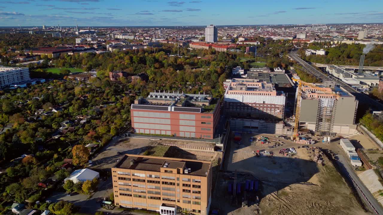 biggest data center building providing cloud computing services in an urban city. blockchain digital database, internet security for sensitive data. Dramatic aerial view flight fly reverse drone