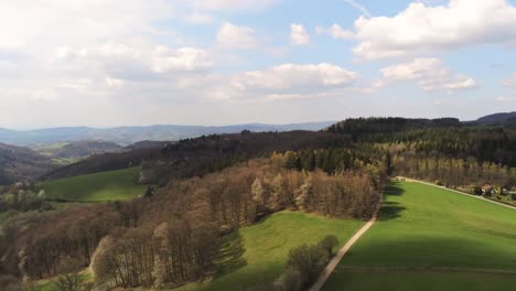 Aerial-view-of-small-German-town-surrounded-by-beautiful-green-hills