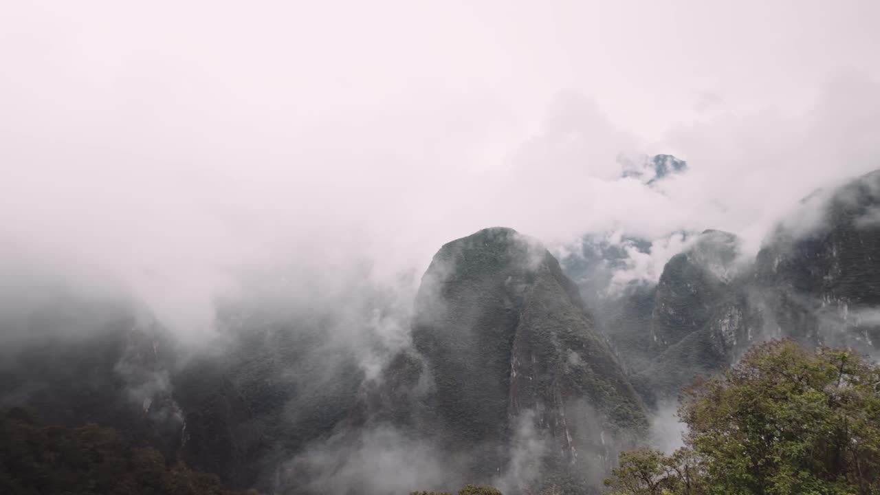 Dramatic Clouds Engulfing Eastern Slope Of The Peruvian Andes At The Historic Sanctuary of Machu Picchu In Cusco, Peru. Panning Shot
