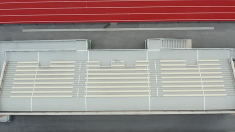 descending aerial on stadium bleachers at sports track, athletic field venue