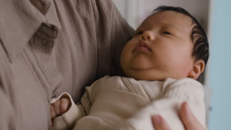 a newborn baby is being held by a parent