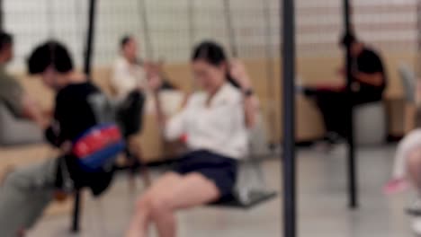 people enjoying a swing indoors, sharing laughter.