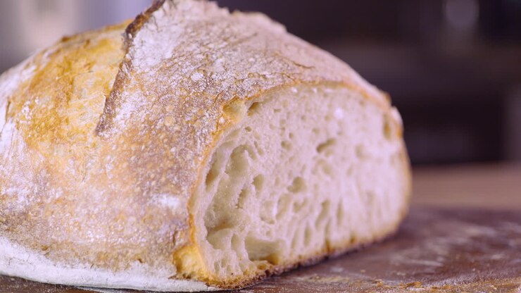 Close Up Of Sourdough Bread On Kitchen Table - pan shot