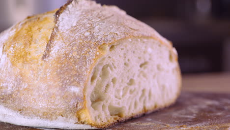 close up of sourdough bread on kitchen table - pan shot