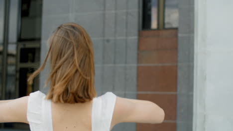 young woman in white dress in the city