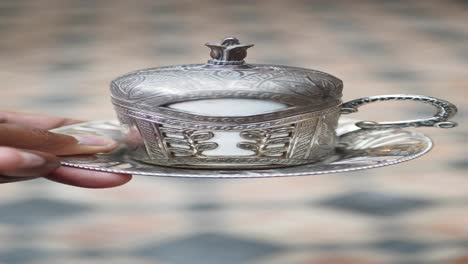 una taza de café turca de plata y un platillo