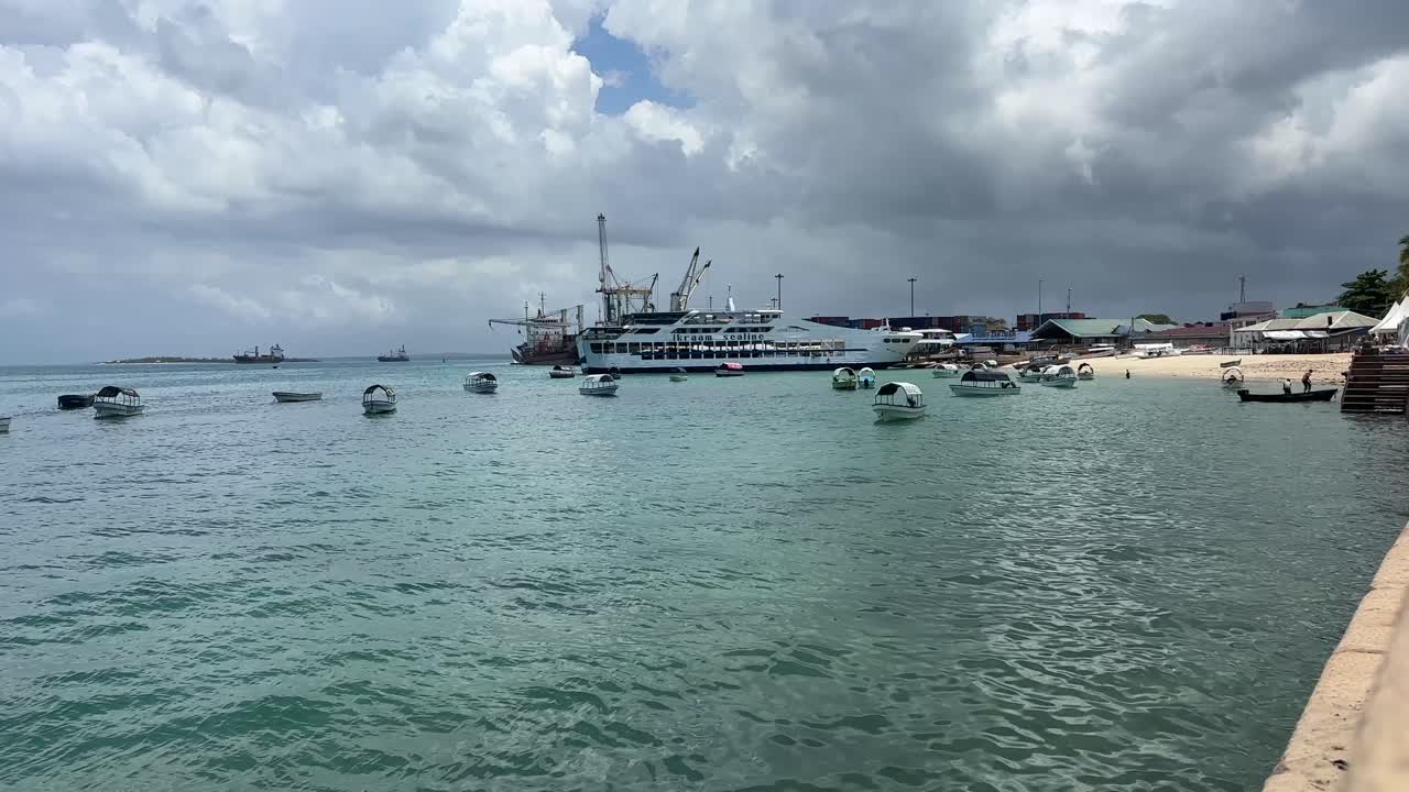 Boats ships at the harbour port in stone town zanzibar city tanzania