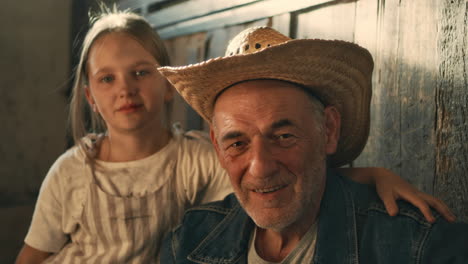 grandfather and granddaughter portrait in rustic setting