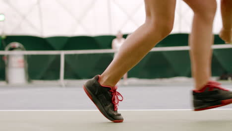 Young-Caucasian-female-tennis-player-serving-during-a-game-or-practice.-120-FPS-slow-motion,-4K-UHD-RAW-graded-footage