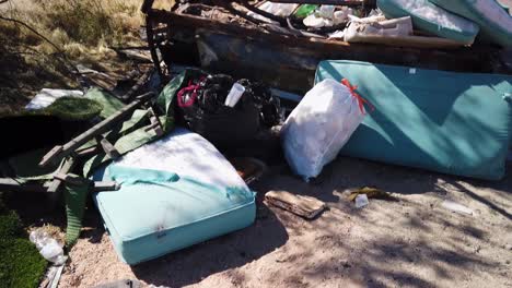 Tilt-up-from-torn-cushions-on-the-roadside-to-a-trailer-full-of-trash