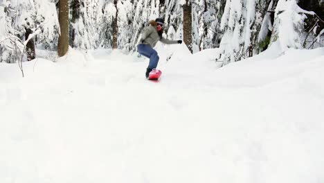 Woman-snowboarding-on-snowy-mountain-4k