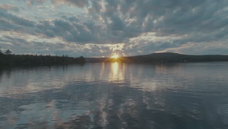 Sunset-beyond-Lake-Hebron-low-angle-aerial-above-lake