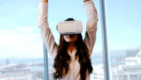 Female-executive-using-virtual-reality-headset-while-performing-yoga