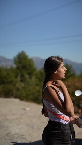 woman with scooter in mountains