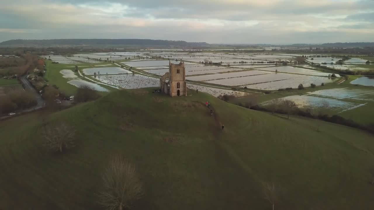 BURROWBRIDGE, SOMERSET, ENGLAND, December 29, 2019: Aerial view of Burrow Mump ruins church with flooded fields on the background.