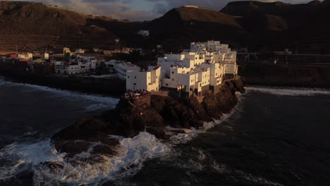 San-Andres-beach-in-Arucas:-aerial-view-of-the-famous-white-buildings-on-San-Andres-beach-and-the-waves-hitting-the-coast