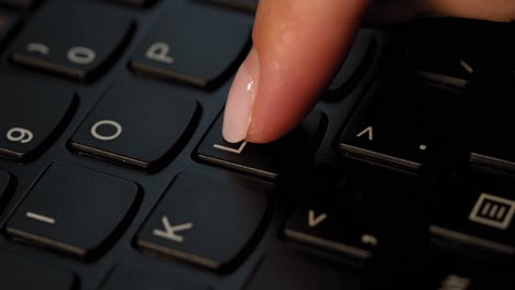 Pushing-L-button-on-the-black-keyboard