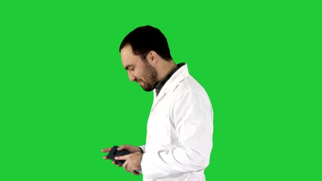 doctor walking and laughing after phone call on a green screen, chroma key