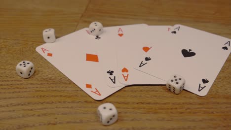 panning shot of poker cards with playing dice on a noble and high quality wooden table in a slow camera movement