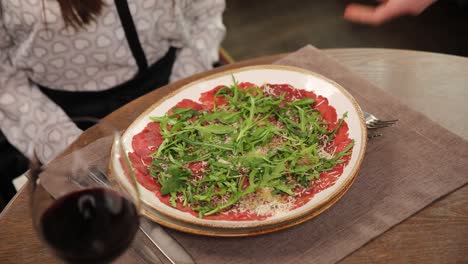 restaurant table setting and carpaccio dish