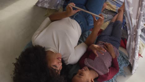 video of african american mother and daughter using tablet