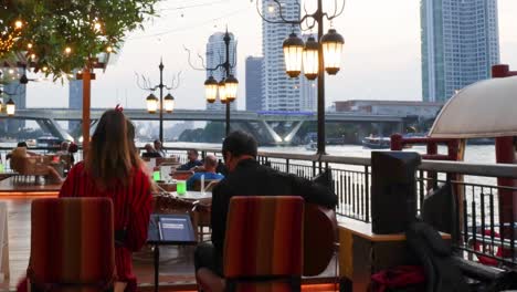 people enjoying a cafe with city views