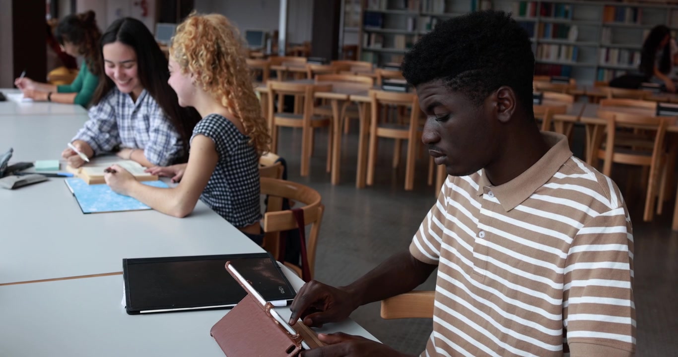 Young Student Using Tablet in University Library