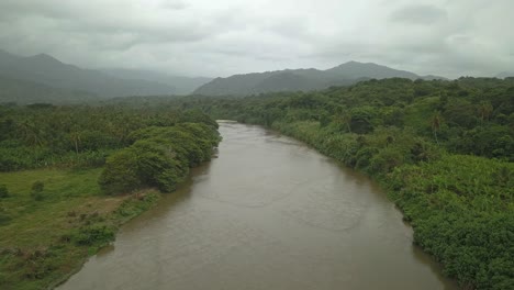 Beautiful-drone-shot-of-a-jungle-river-in-Tayrona-national-park-in-Colombia