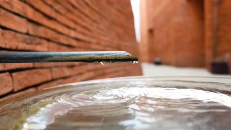 water droplet falling from a fountain's edge