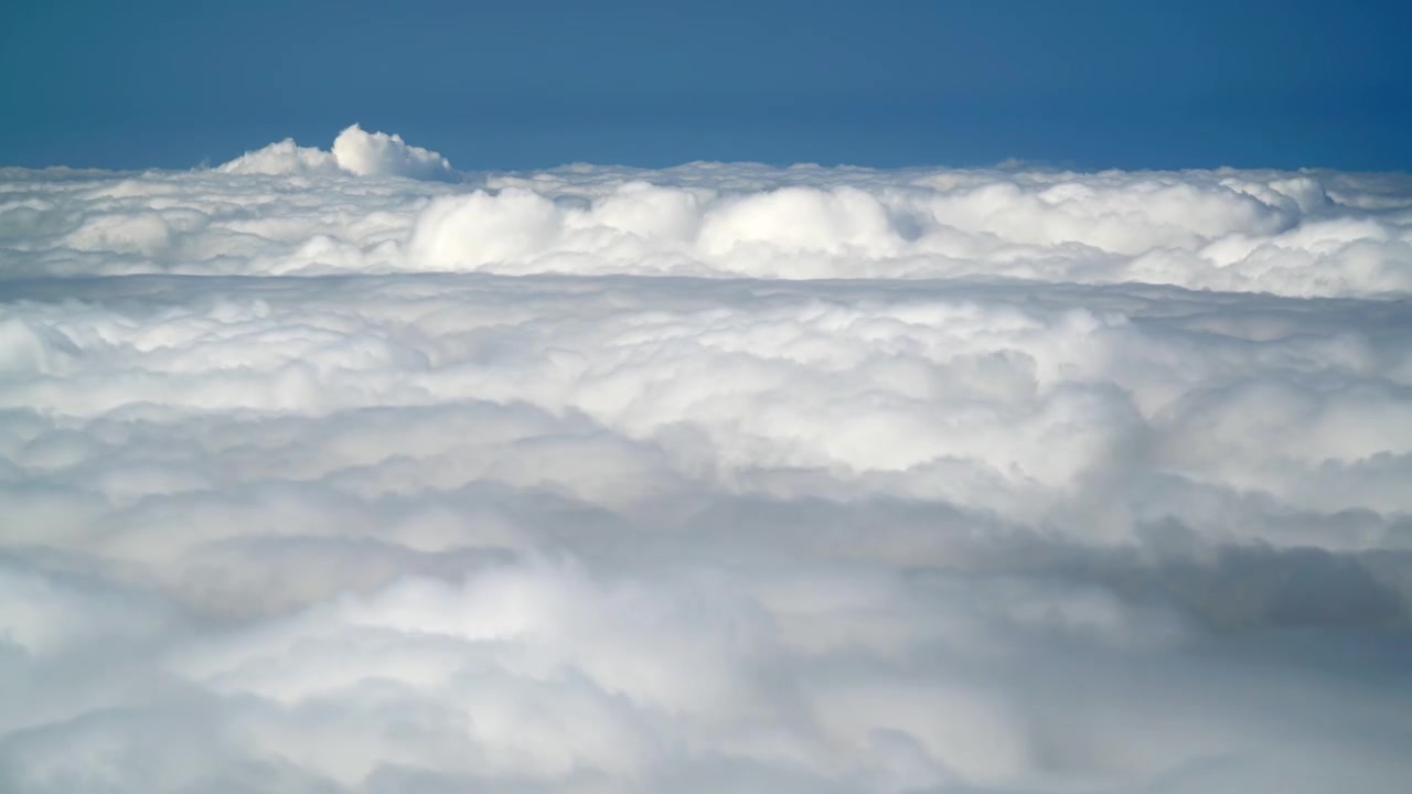 Aerial View of Dense White Clouds Under Clear Blue Sky