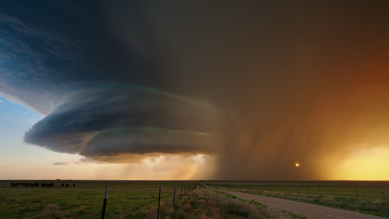 Dramatic Supercell Thunderstorm at Sunset over a Rural Landscape