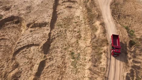 red dump truck in a sand quarry