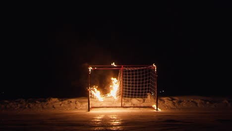 textile grid of hokey gate burns on ice rink at winter night