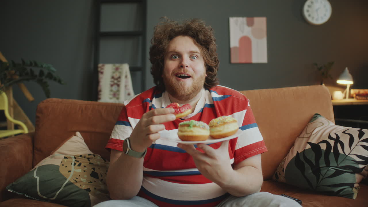 Man Eating Donuts and Watching TV