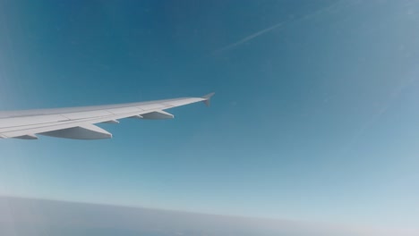 View-of-the-wing-of-a-plane-from-inside-whilst-flying