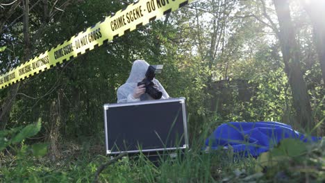 crime scene - do not cross tape and photographer collecting evidence for investigation