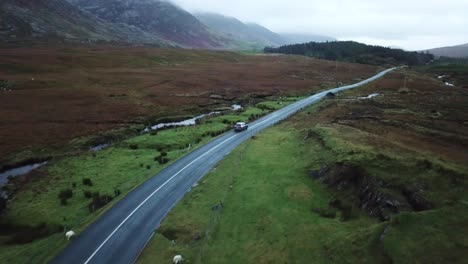 aerial view, two cars pass each other on a road in connemara, ireland