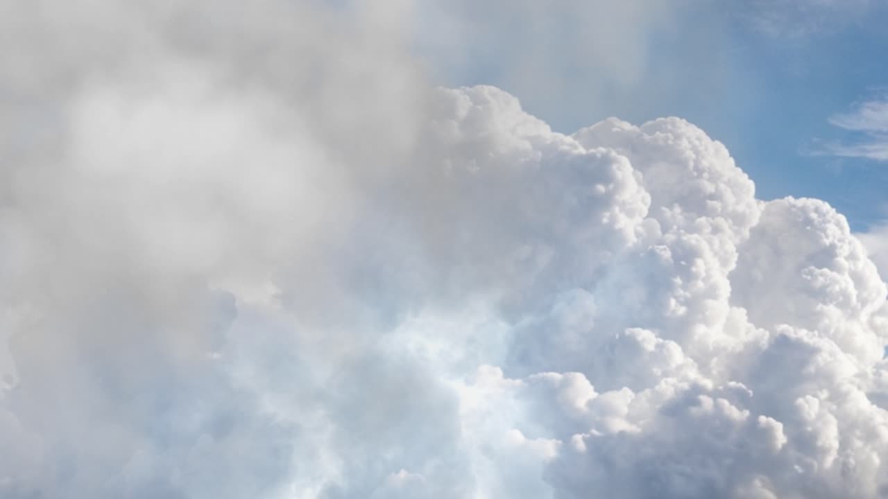 Thunderstorm over the cumulonimbus clouds in the blue sky.